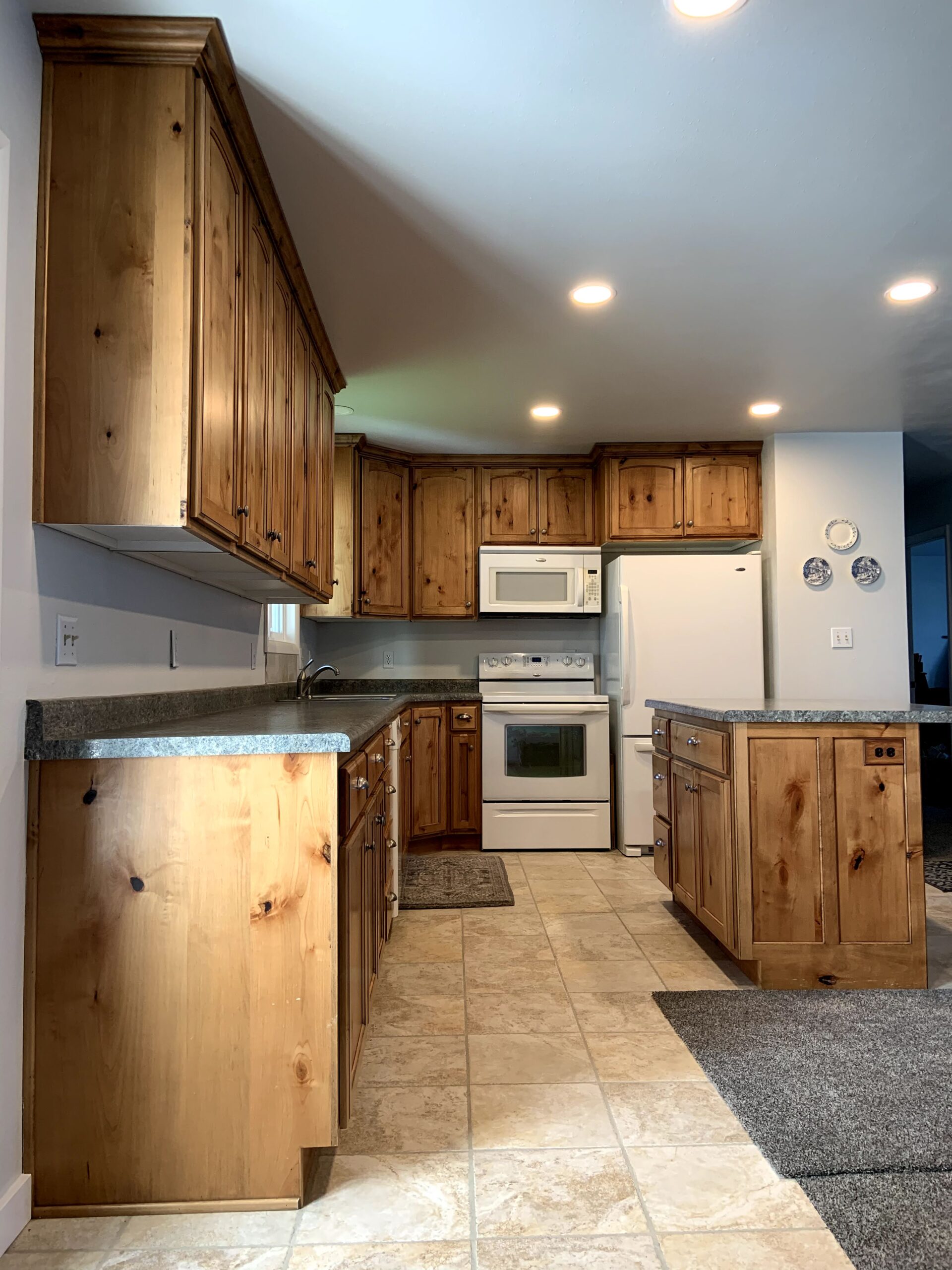 Before version of knotty wood cabinets from a low angle