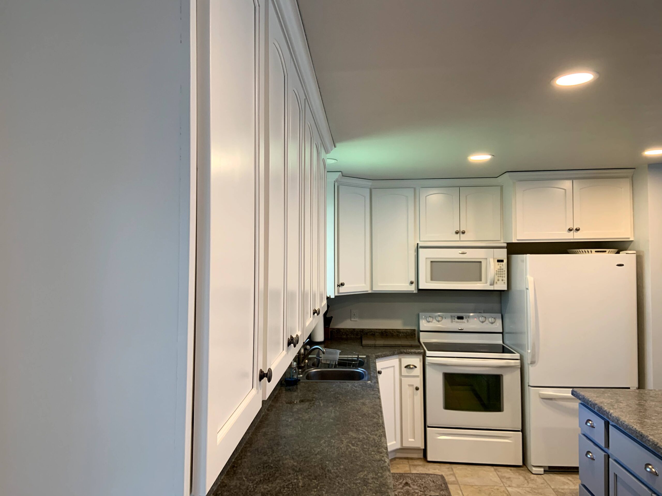 Close-up after photo of satin white upper cabinets