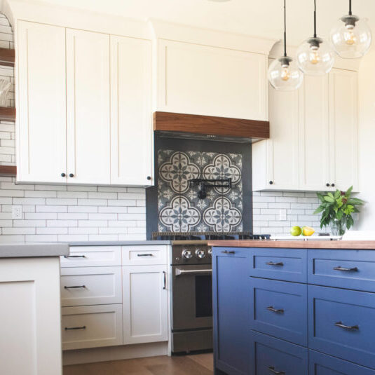 Clean white cabinets with blue accent island cabinets