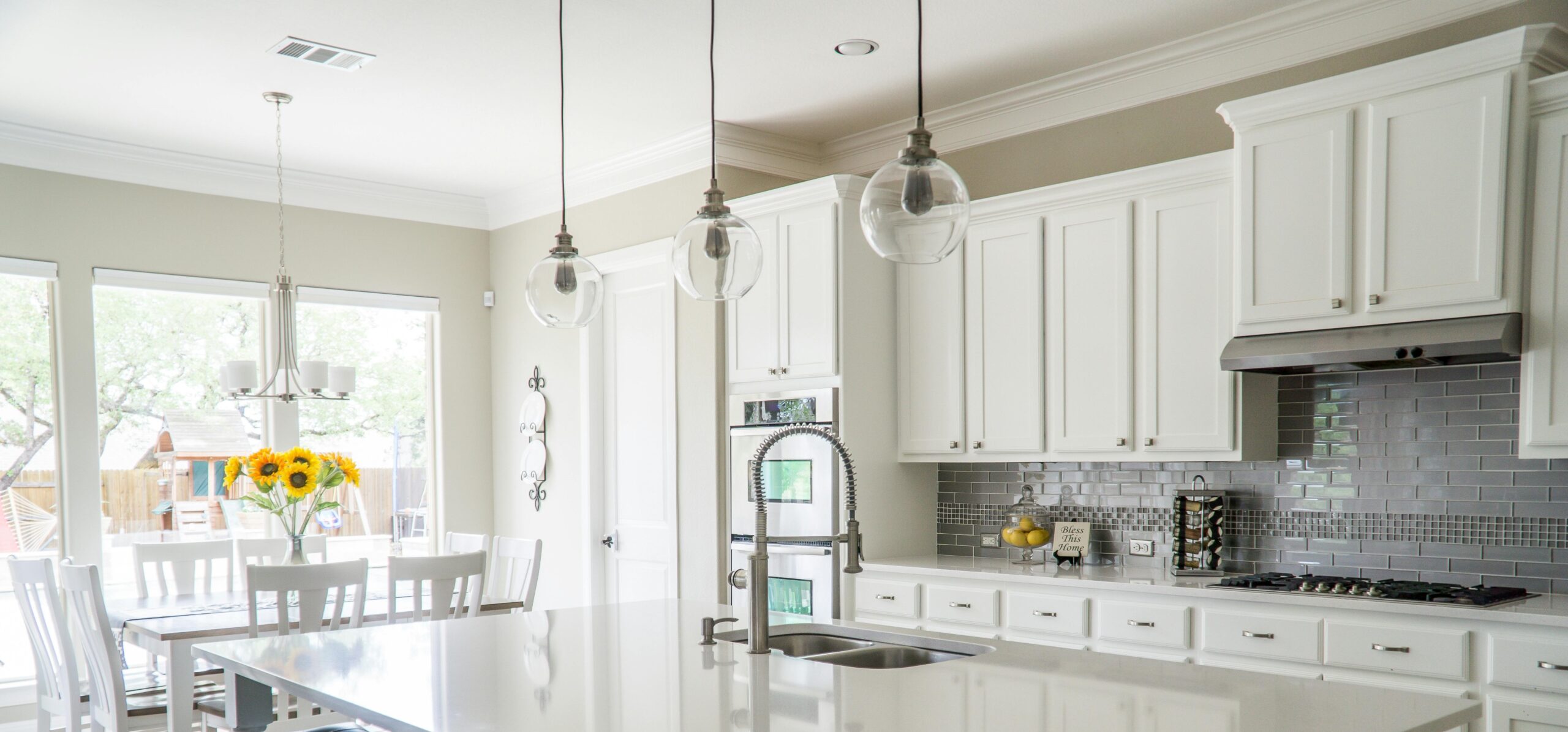 Background photo of white cabinets with clean white countertops and lots of natural light